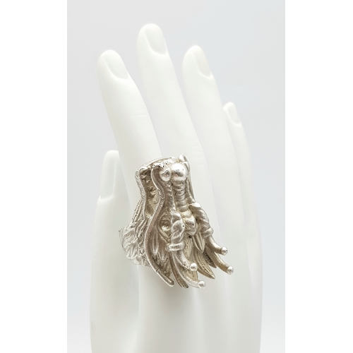 207 - A STERLING SILVER DRAGONS HEAD RING, STUNNING DETAIL AND HEAVY. Size R1/2, 4.2cm dragon head length,... 