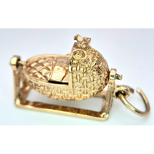 288 - A 9K YELLOW GOLD BABY CRIB CHARM, WHICH MOVES. 2.6cm length, 3.7g total weight. Ref: SC 8010