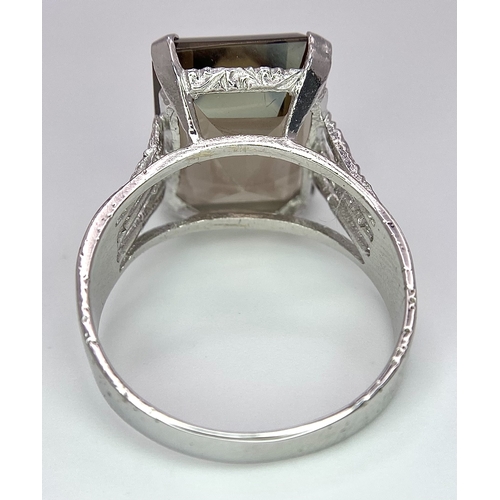 292 - A 9K WHITE GOLD SMOKEY QUARTZ SET RING. 5.6G. SIZE S.