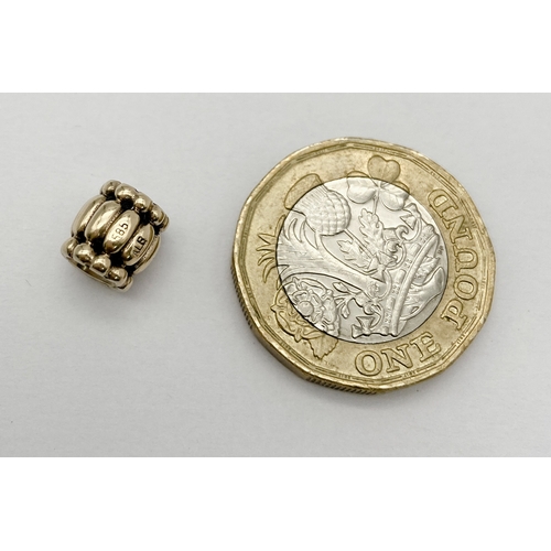 453 - A 14K YELLOW GOLD PANDORA CHARM. 7mm length, 2.2g weight. Ref: SC 8134