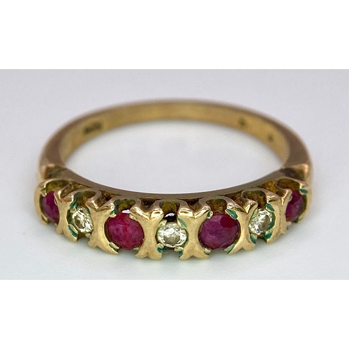 477 - A vintage, 9 K yellow gold ring with a band of alternating round cut diamonds and rubies. Size: N, w... 