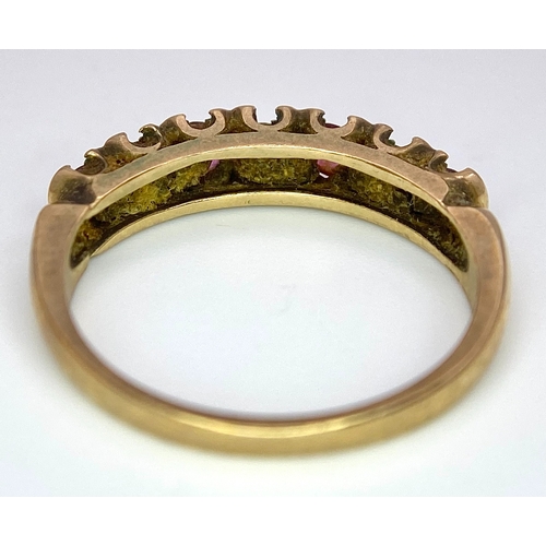 477 - A vintage, 9 K yellow gold ring with a band of alternating round cut diamonds and rubies. Size: N, w... 