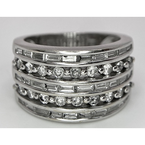 27 - AN 18K WHITE GOLD 5 ROW DIAMOND RING. MIXTURE OF ROUND BRILLIANT CUTS AND BAGUETTE CUT DIAMONDS. App... 