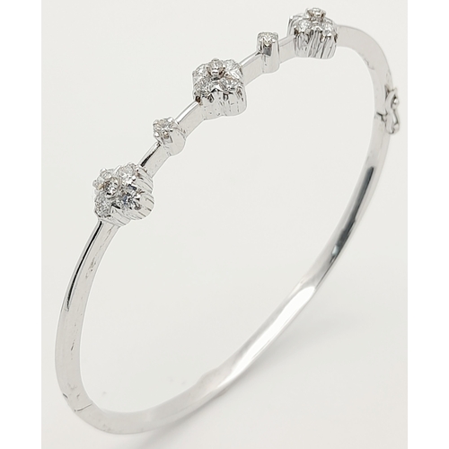 61 - AN 18K WHITE GOLD DIAMOND SET BANGLE. 0.30ctw, 5.1cm inner diameter, 8.5g total weight. Ref: SC 8069