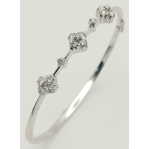 61 - AN 18K WHITE GOLD DIAMOND SET BANGLE. 0.30ctw, 5.1cm inner diameter, 8.5g total weight. Ref: SC 8069