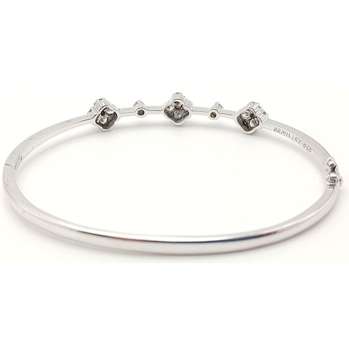 61 - AN 18K WHITE GOLD DIAMOND SET BANGLE. 0.30ctw, 5.1cm inner diameter, 8.5g total weight. Ref: SC 8069