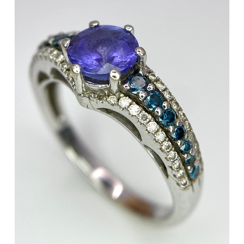 268 - A 14K White Gold Tanzanite and Diamond Ring. Central oval cut tanzanite with blue and white diamonds... 