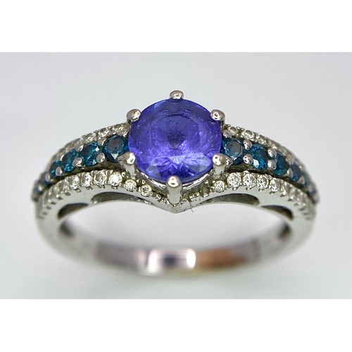 268 - A 14K White Gold Tanzanite and Diamond Ring. Central oval cut tanzanite with blue and white diamonds... 