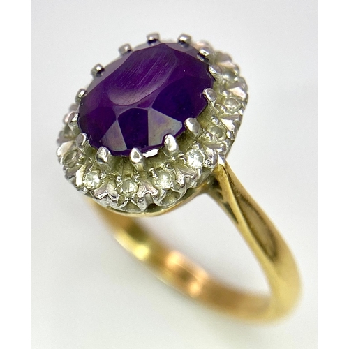 275 - An 18K Yellow Gold Amethyst and Diamond Ring. Central amethyst with a diamond halo. Size M. 4.4g tot... 