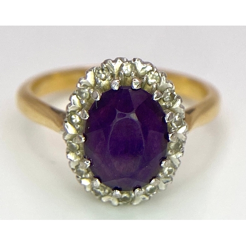 275 - An 18K Yellow Gold Amethyst and Diamond Ring. Central amethyst with a diamond halo. Size M. 4.4g tot... 