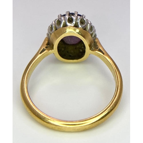 275 - An 18K Yellow Gold Amethyst and Diamond Ring. Central amethyst with a diamond halo. Size M. 4.4g tot... 