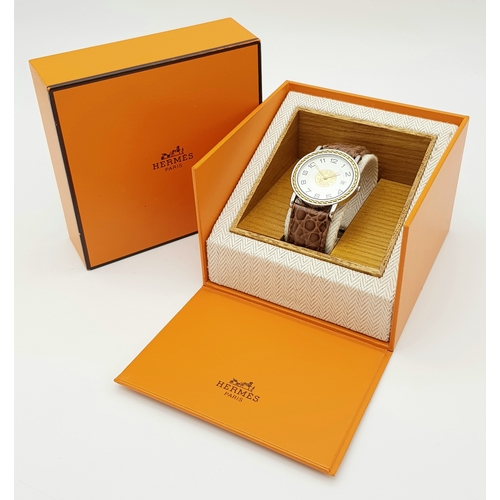 284 - A FABULOUS HERMES OF PARIS GENTS WATCH WITH WHITE DIAL AND CIRCULAR CENTRAL LOGO ON A BROWN CROCODIL... 