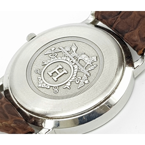 284 - A FABULOUS HERMES OF PARIS GENTS WATCH WITH WHITE DIAL AND CIRCULAR CENTRAL LOGO ON A BROWN CROCODIL... 