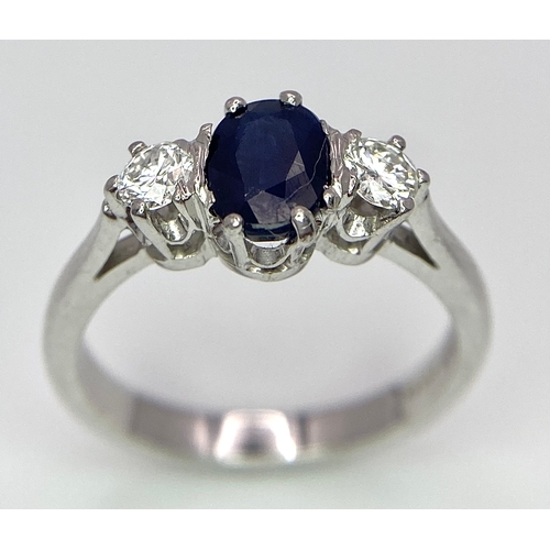 33 - AN 18K WHITE GOLD, DIAMOND AND SAPPHIRE 3 STONE RING. OVAL BLUE SAPPHIRE - 0.75CT AND 0.30CT OF ROUN... 