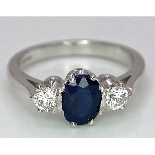 33 - AN 18K WHITE GOLD, DIAMOND AND SAPPHIRE 3 STONE RING. OVAL BLUE SAPPHIRE - 0.75CT AND 0.30CT OF ROUN... 