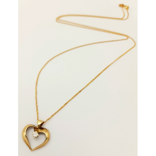 386 - A 9 K yellow gold chain necklace with a heart pendant adorned with a single round cut diamond, chain... 