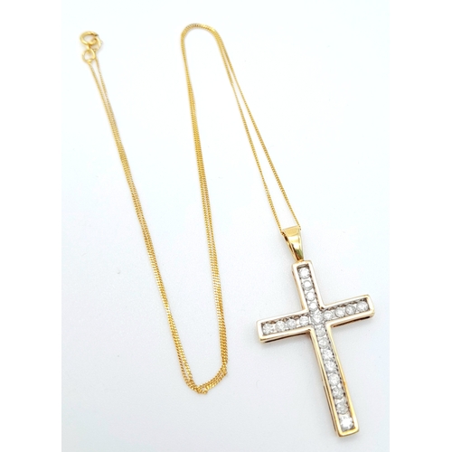 239 - A 10K yellow gold diamond set cross pendant set on 16