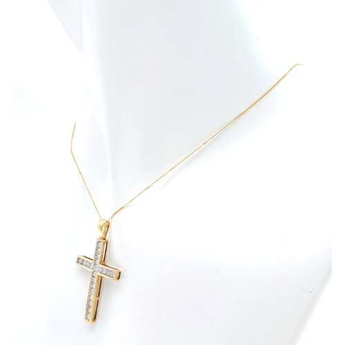 239 - A 10K yellow gold diamond set cross pendant set on 16