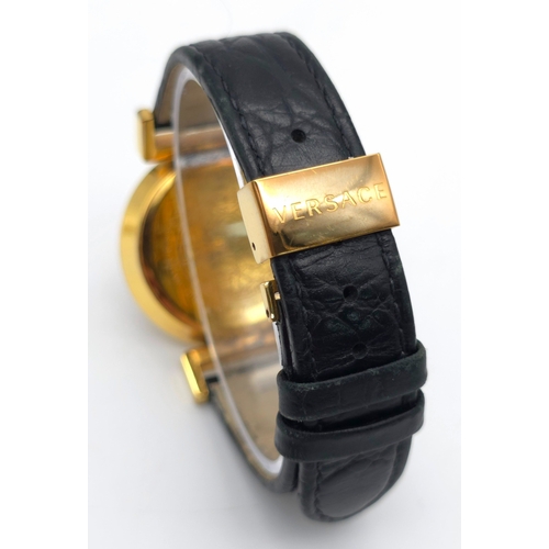 283 - A Versace Designer Quartz Ladies Watch. Black leather and gilded strap and case - 35mm. Black dial w... 