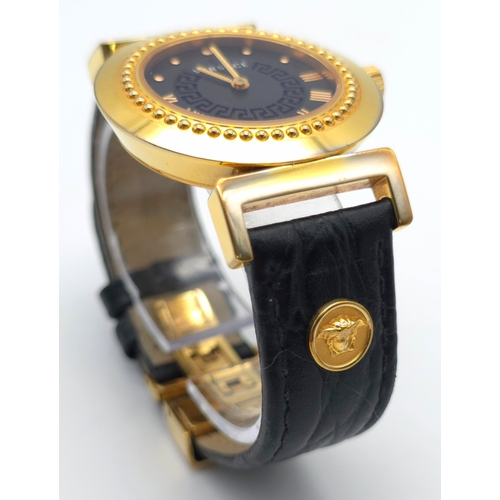 283 - A Versace Designer Quartz Ladies Watch. Black leather and gilded strap and case - 35mm. Black dial w... 