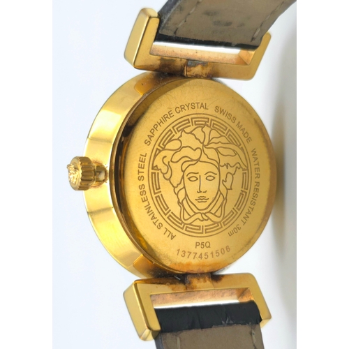 283 - A Versace Designer Quartz Ladies Watch. Black leather and gilded strap and case - 35mm. Black dial w... 