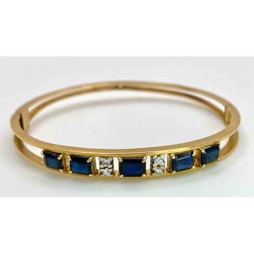 29 - A 14K (TESTED AS) YELLOW GOLD BANGLE SET WITH 5 SAPPHIRES AND 4 DIAMONDS, 6CM DIAMETER, 15.9G (DIA:0... 