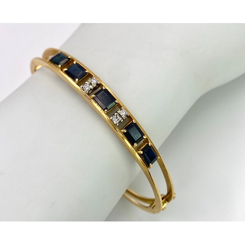 29 - A 14K (TESTED AS) YELLOW GOLD BANGLE SET WITH 5 SAPPHIRES AND 4 DIAMONDS, 6CM DIAMETER, 15.9G (DIA:0... 