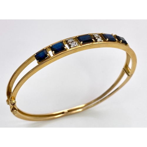 29 - A 14K (TESTED AS) YELLOW GOLD BANGLE SET WITH 5 SAPPHIRES AND 4 DIAMONDS, 6CM DIAMETER, 15.9G (DIA:0... 