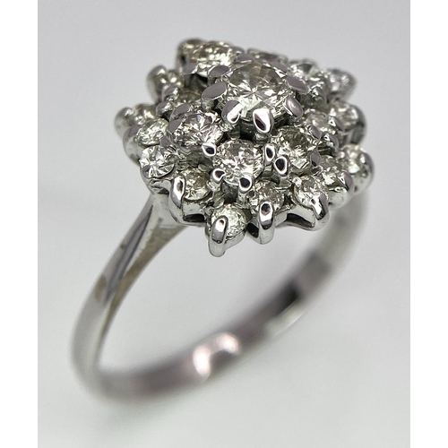 296 - An 18K White Gold Diamond Floral Cluster Ring. Size O. 4.5g total weight. Ref: 16987