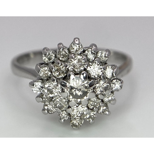 296 - An 18K White Gold Diamond Floral Cluster Ring. Size O. 4.5g total weight. Ref: 16987