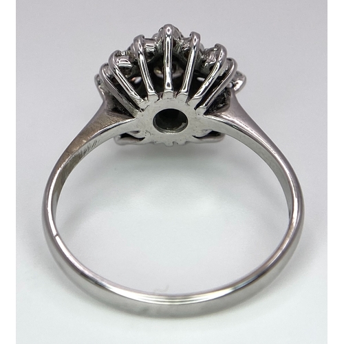 296 - An 18K White Gold Diamond Floral Cluster Ring. Size O. 4.5g total weight. Ref: 16987