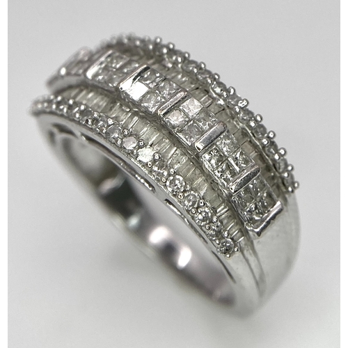 311 - A 9K White Gold Mixed Cut Diamond Ring. Five rows of, square, round and baguette cut diamonds. Size ... 