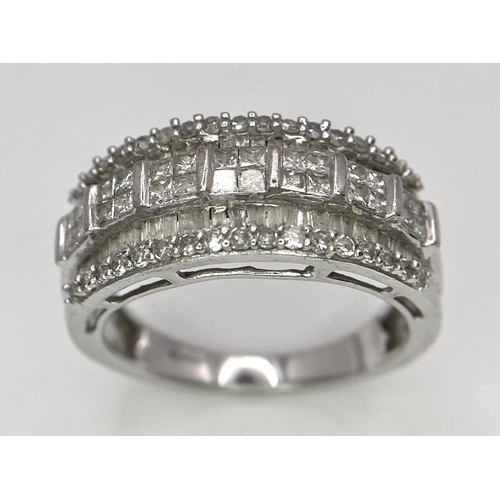 311 - A 9K White Gold Mixed Cut Diamond Ring. Five rows of, square, round and baguette cut diamonds. Size ... 