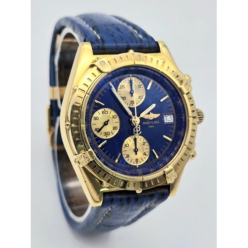 316 - An 18K Gold Breitling Chronograph Gents Watch. Breitling blue leather strap with 18k gold clasp. 18k... 