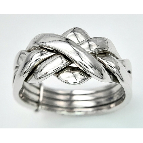 334 - A 9K WHITE GOLD PUZZLE RING. 5.4G. SIZE N.