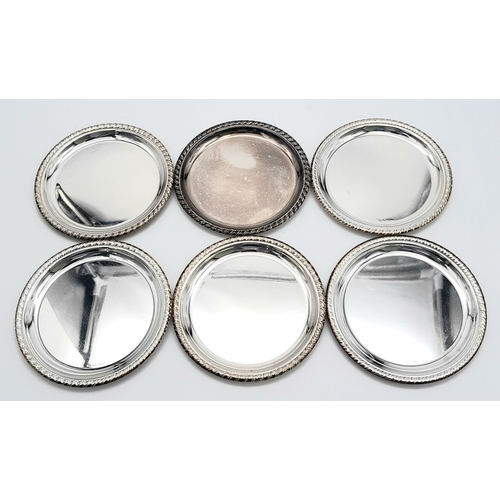 340 - A SET OF SIX SOLID SILVER COASTERS IN 800 SILVER , NICELY EDGED AND BEING 10cms in DIAMETER .    316... 