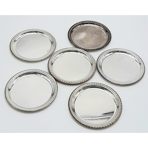 340 - A SET OF SIX SOLID SILVER COASTERS IN 800 SILVER , NICELY EDGED AND BEING 10cms in DIAMETER .    316... 