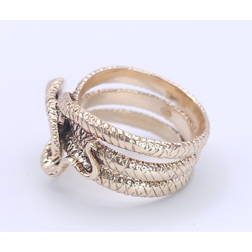 366 - A 9K Yellow Gold Serpent Ring. A three band coiled body, ready to strike with ruby eyes. Size M 1/2.... 