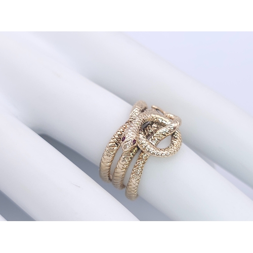 366 - A 9K Yellow Gold Serpent Ring. A three band coiled body, ready to strike with ruby eyes. Size M 1/2.... 