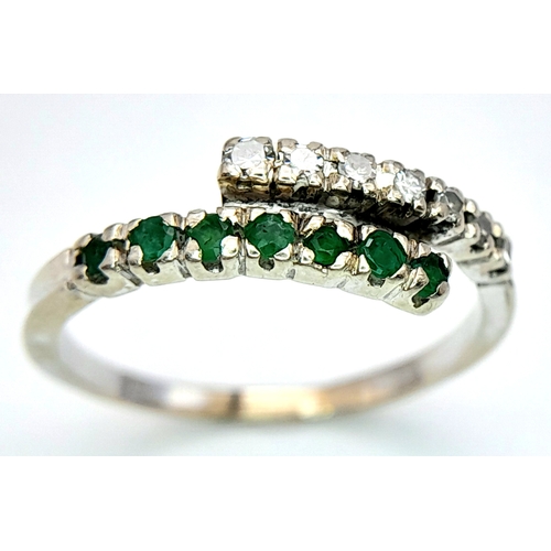 481 - A 14K WHITE GOLD DIAMOND & EMERALD 2 ROW CROSSOVER RING. Size L, 1.6g total weight. Ref: SC 8077