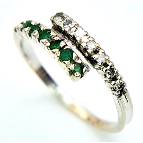 481 - A 14K WHITE GOLD DIAMOND & EMERALD 2 ROW CROSSOVER RING. Size L, 1.6g total weight. Ref: SC 8077