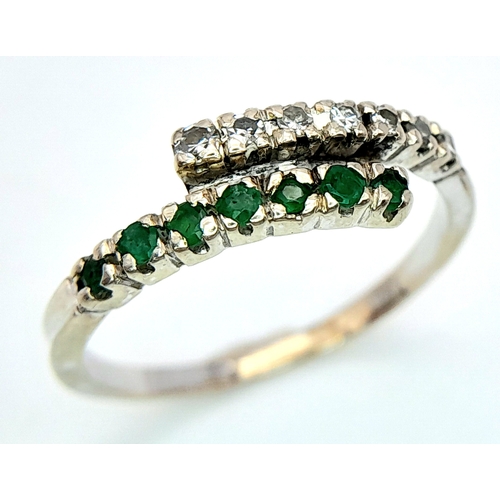 481 - A 14K WHITE GOLD DIAMOND & EMERALD 2 ROW CROSSOVER RING. Size L, 1.6g total weight. Ref: SC 8077