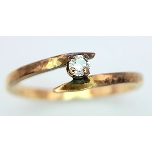 547 - A 14ct Yellow Gold (tested as) Diamond Crossover Ring, 0.05ct diamond, size I, 1.3g weight.

ref: SH... 