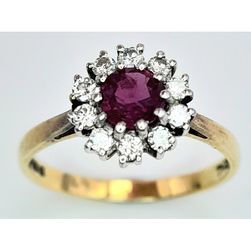 318 - An 18K Yellow Gold, Ruby and Diamond Ring. Round cut ruby with a diamond halo. Size M 1/2. 2.8g tota... 