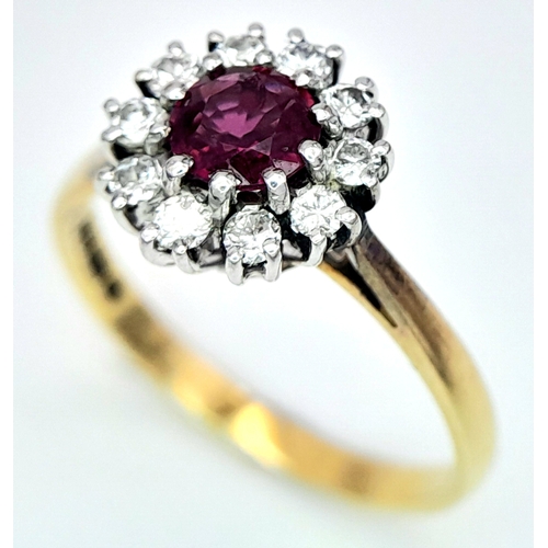 318 - An 18K Yellow Gold, Ruby and Diamond Ring. Round cut ruby with a diamond halo. Size M 1/2. 2.8g tota... 