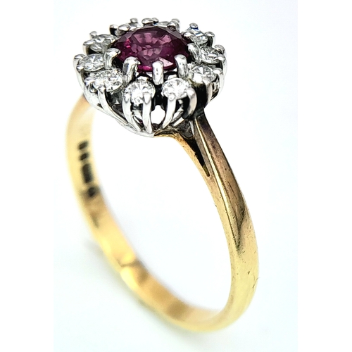 318 - An 18K Yellow Gold, Ruby and Diamond Ring. Round cut ruby with a diamond halo. Size M 1/2. 2.8g tota... 