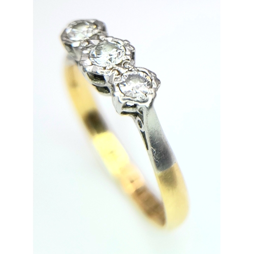 355 - A VINTAGE 18K YELLOW GOLD, PLATINUM AND DIAMOND 3 STONE RING. 0.15CT. 2.2G. SIZE O