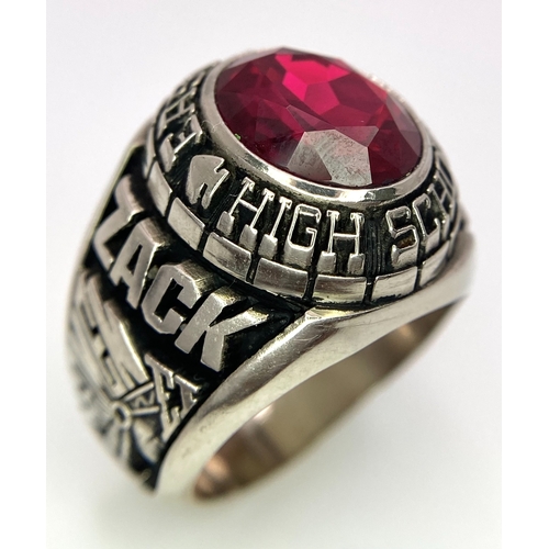 304 - A 10K White Gold and Ruby Gents High School Ring. Size P 1/2. 18g total weight. Ref: 17043