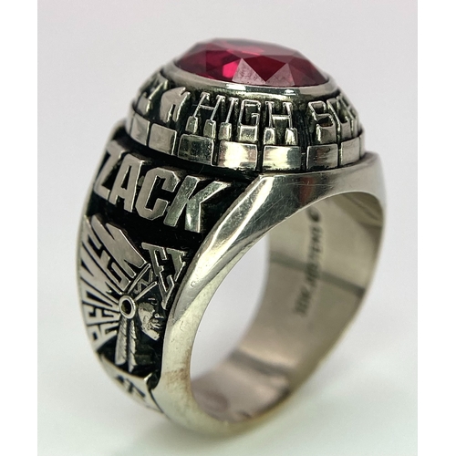 304 - A 10K White Gold and Ruby Gents High School Ring. Size P 1/2. 18g total weight. Ref: 17043