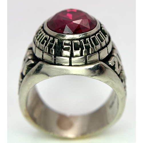 304 - A 10K White Gold and Ruby Gents High School Ring. Size P 1/2. 18g total weight. Ref: 17043